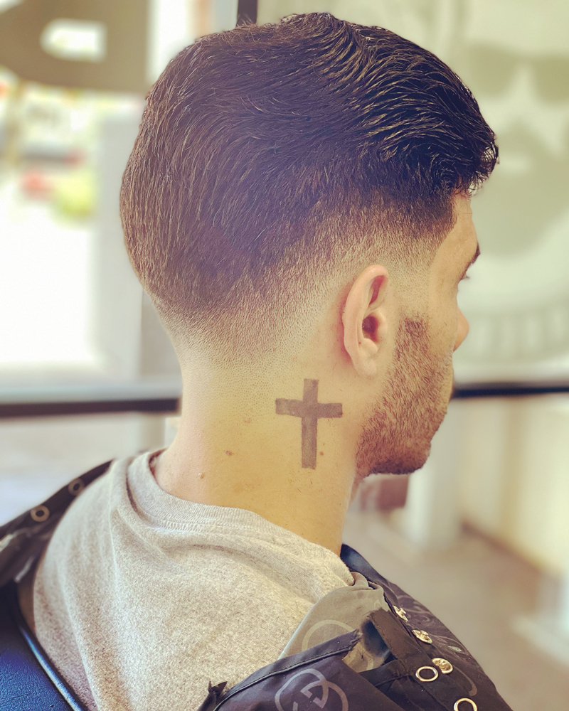 Back view of a textured taper fade with a clean blended nape and neck line