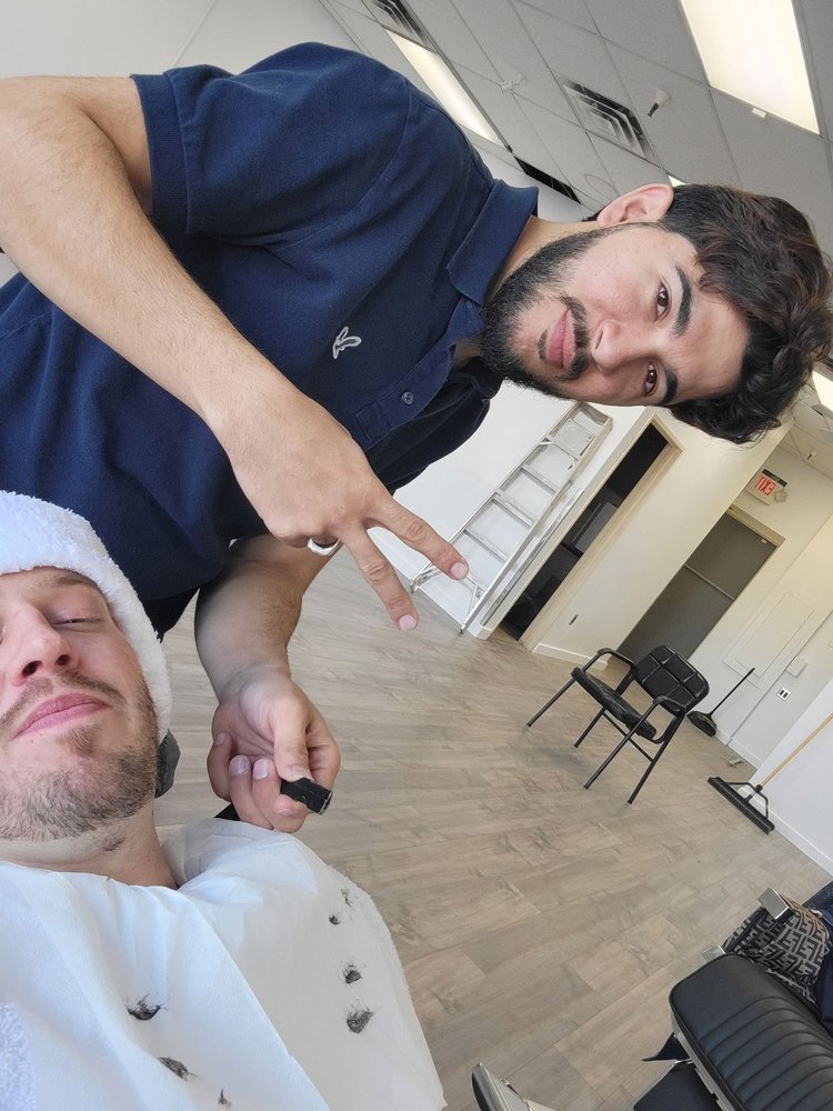 Client relaxing with a hot towel wrap during a shave at the barbershop