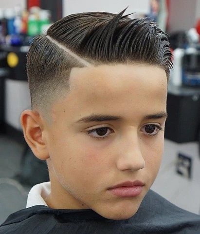 Boy's comb over with a hard part and clean high fade