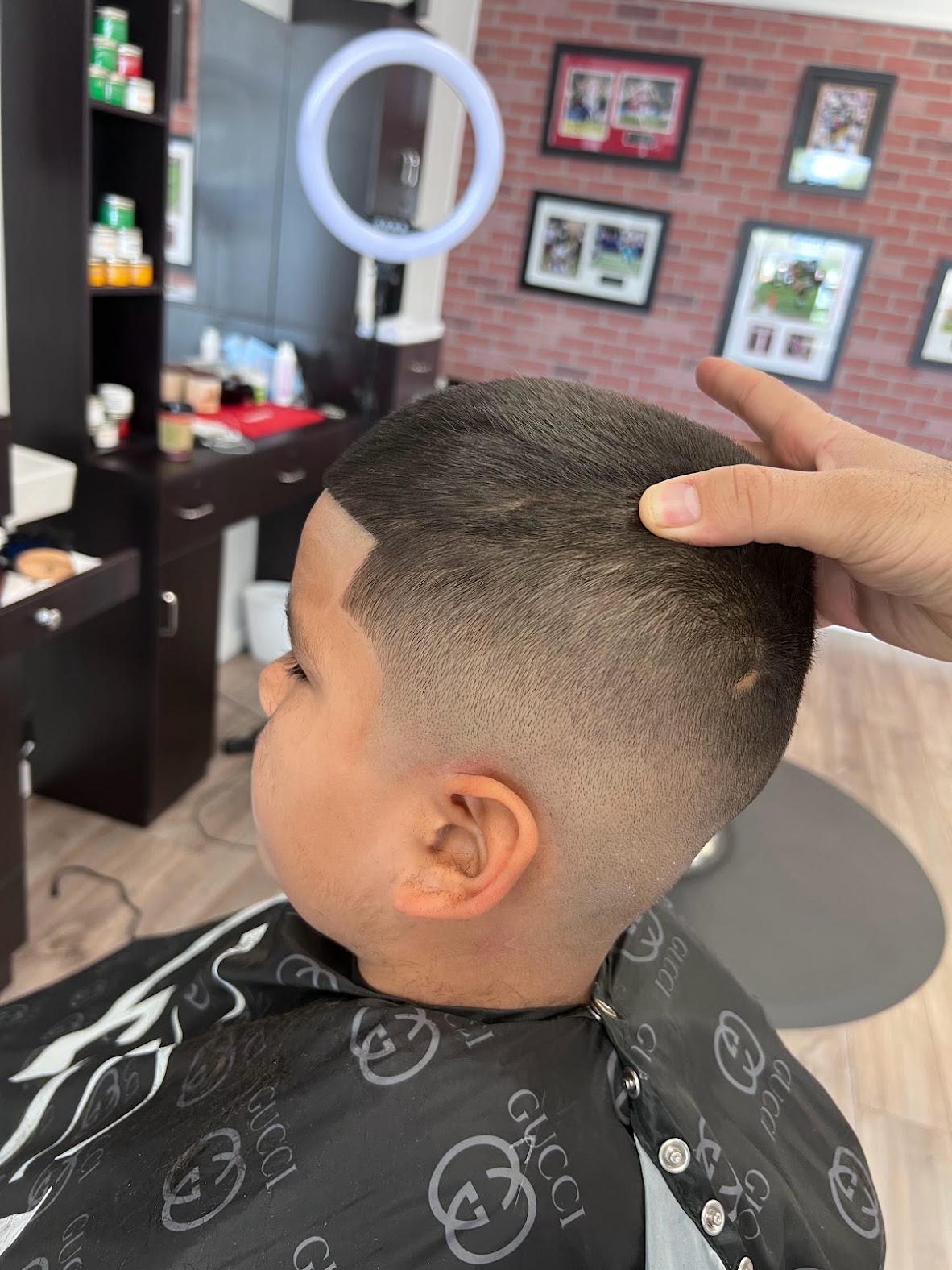 Kids' buzz cut with a crisp line-up and blended skin fade