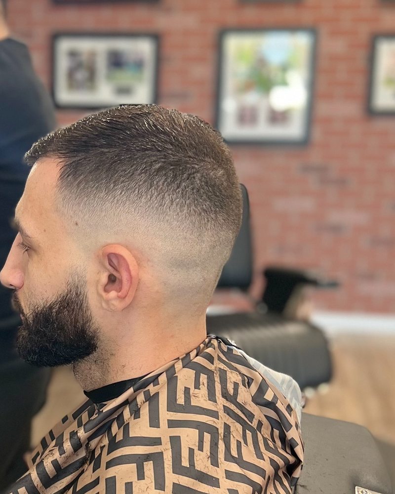 Short crop with a high skin fade and full beard blended at the sideburn