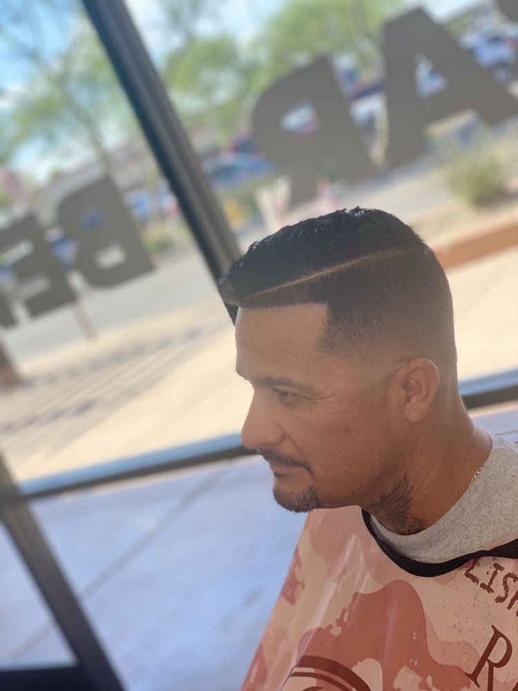 Classic side part with a mid fade and razor-shaved parting