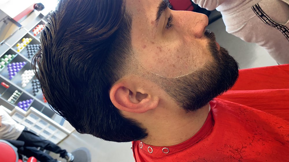 Full beard sculpted with a crisp cheek line and blended taper by a Glendale barber