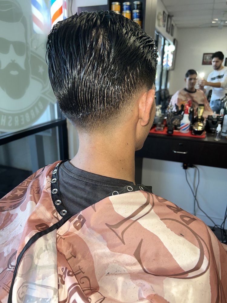 Back view of a slicked-back taper with a clean blended nape